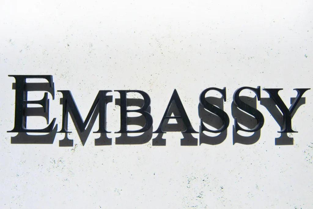 A sign that says "Embassy" in black letters