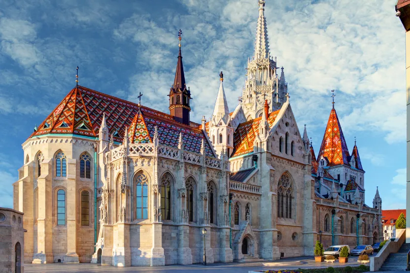 The exterior of the Matthias Church in Budapest on a clear and bright day.