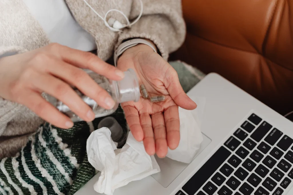 A woman taking medication.