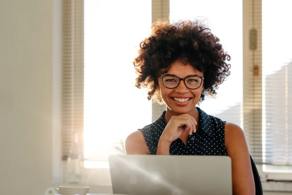 Smiling woman on a laptop