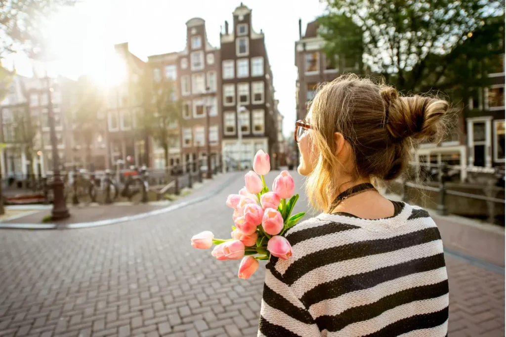 Woman carrying Tulips in Amsterdam