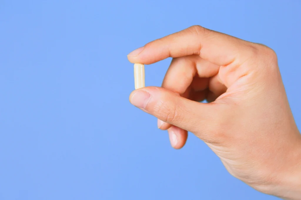 Hand holding pill