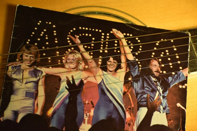An ABBA record on an old guitar.
