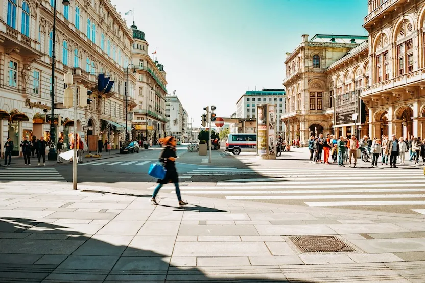 A woman walking around Vienna on a sunny day.