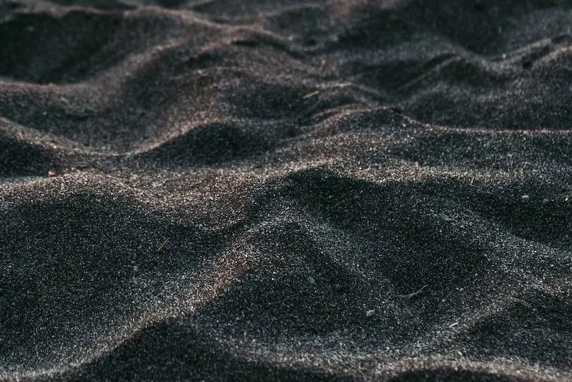 The black sand of Santorini's beaches.