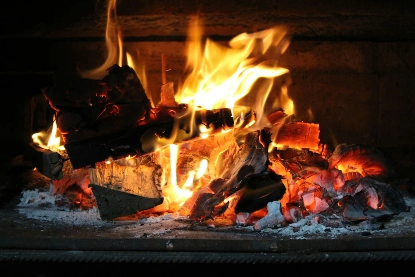 A fire roaring in a fireplace.