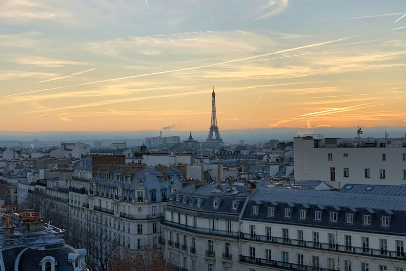 The Eiffel Tower in the distance at sunset.