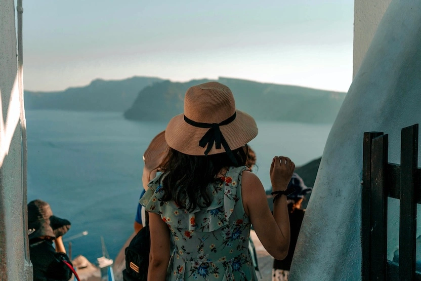 A woman wandering the streets of Santorini.