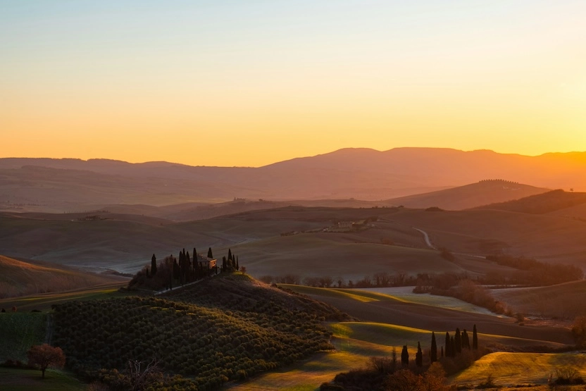 A sunset over the rolling hills in Tuscany. 