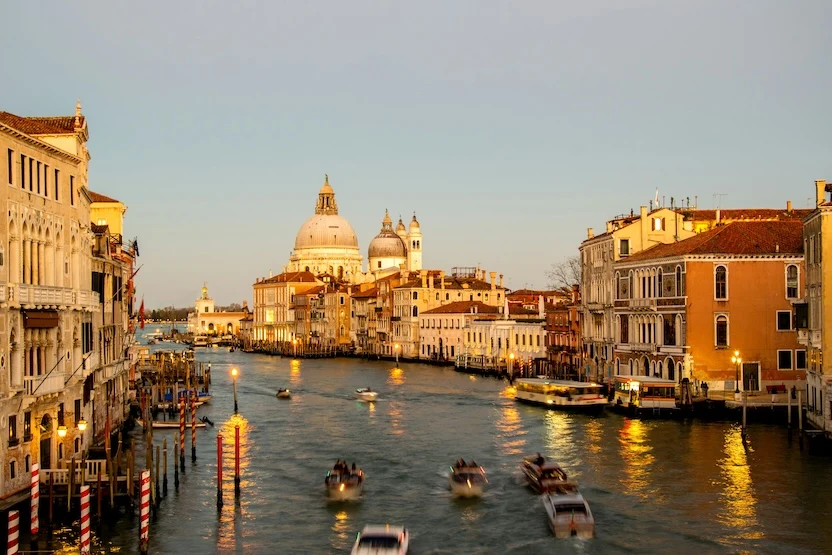 The ancient city of Venice at dusk, saturated in amber light. 