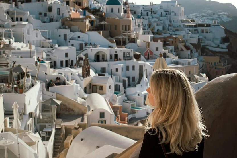 A woman looks out over Santorini, Greece.