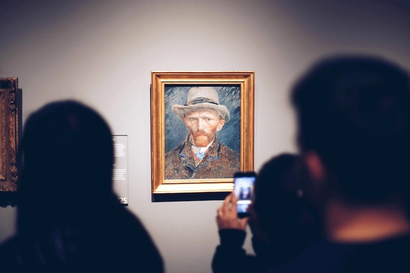 Travelers looking at Van Gogh paintings.