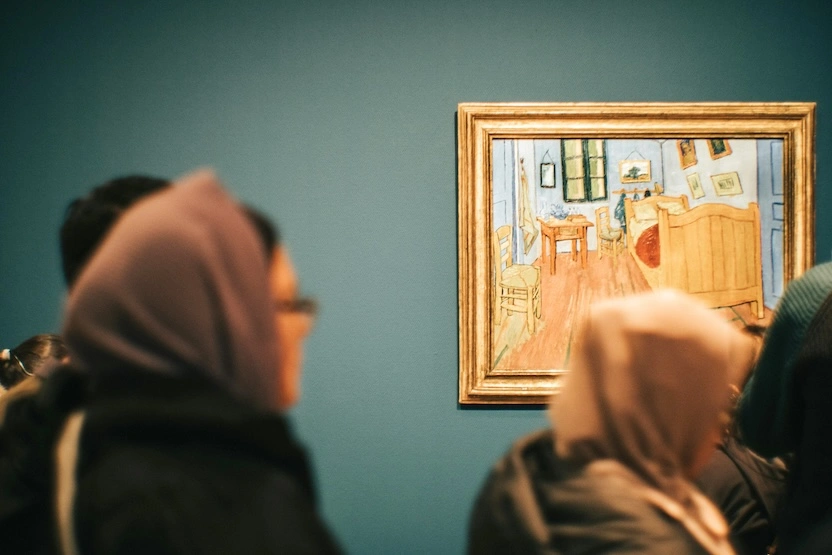 Travelers looking at famous paintings by Van Gogh.