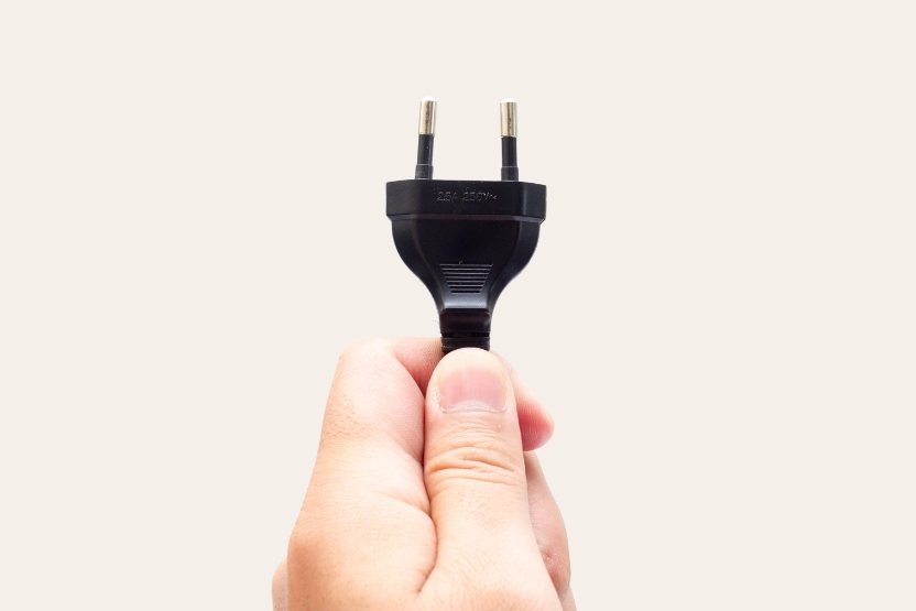 Hand holding a Germany plug