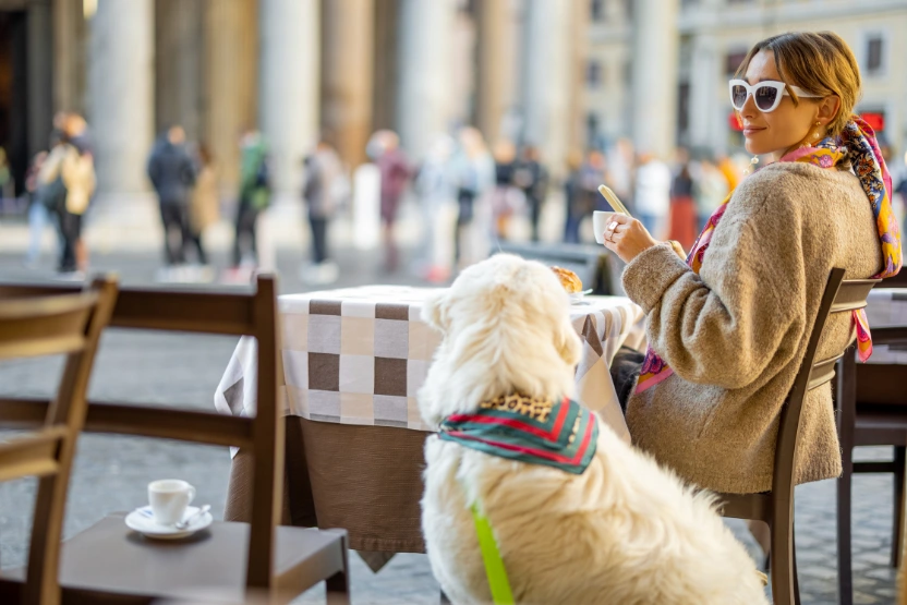 Woman at a restaurant in Rome with a dog