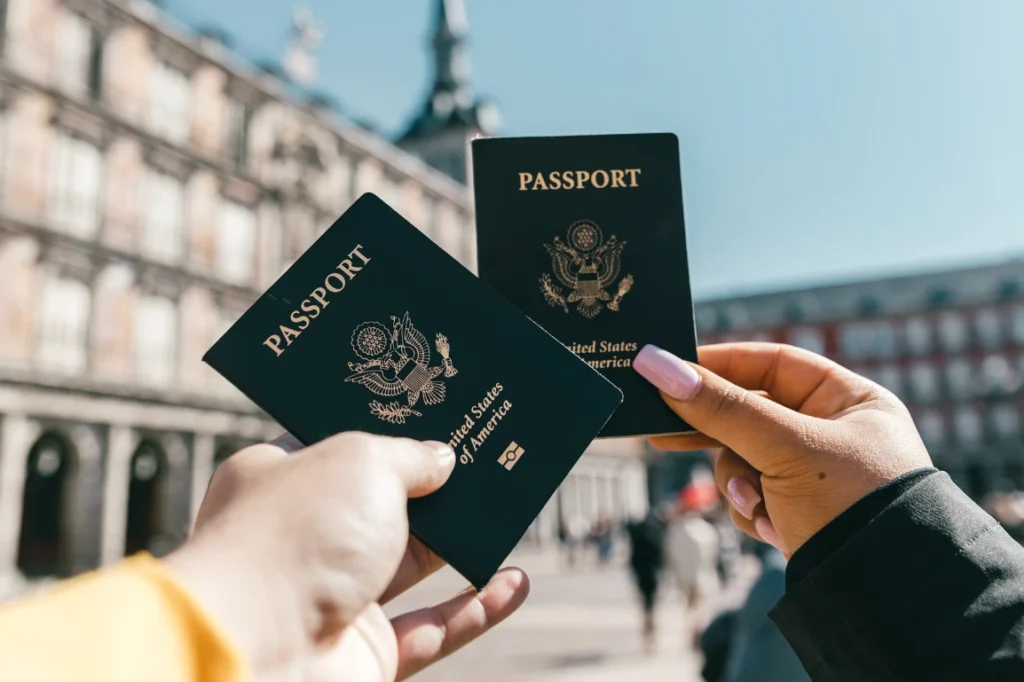 Travelers holding up US passports