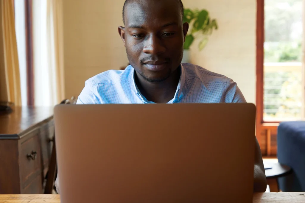 Man typing on his laptop