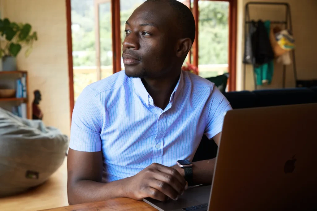 Man on laptop, thinking