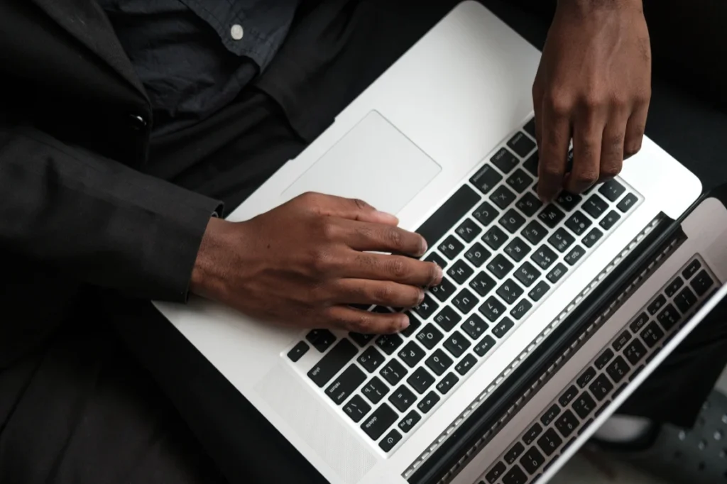 Man typing on his laptop