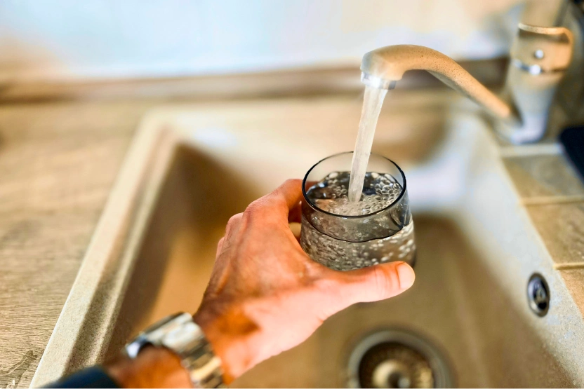 Filling a glass with water at the kitchen sink