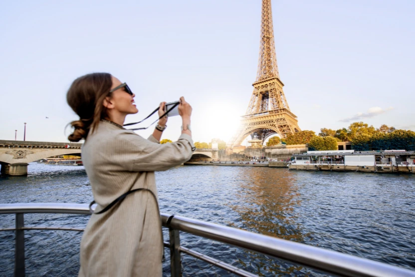 Female tourist taking a photo of the Eiffel Tower