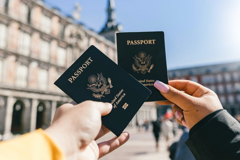 A couple holding up US passports
