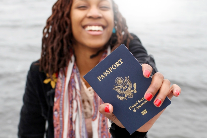 Woman holding up a US passport