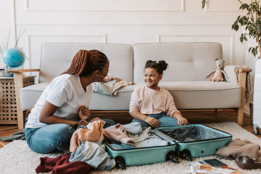Mother and daughter packing a suitcase together