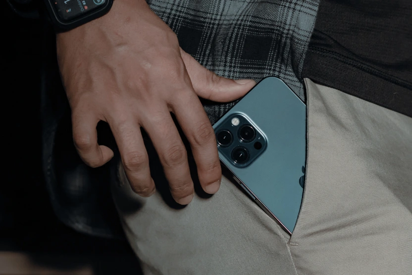 Man reaching in his pocket for his cellphone