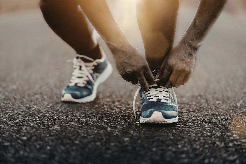 A runner tying his shoes