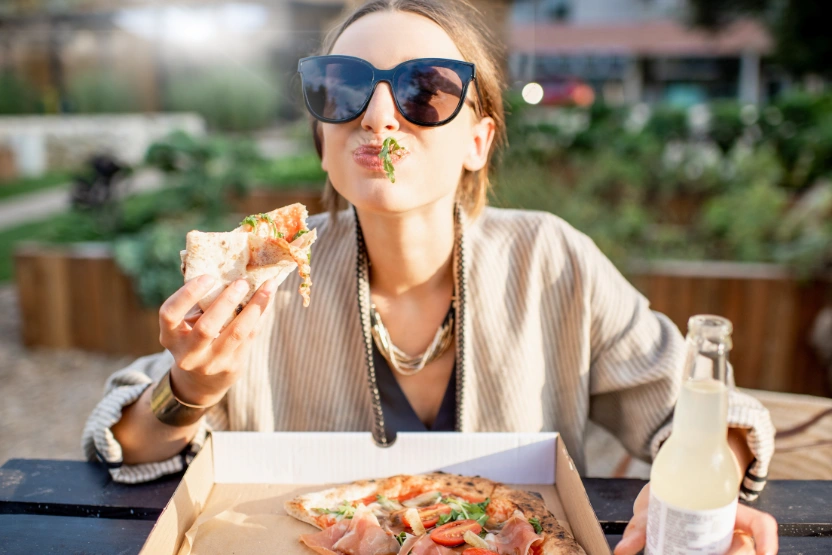 Woman eating pizza in Portugal