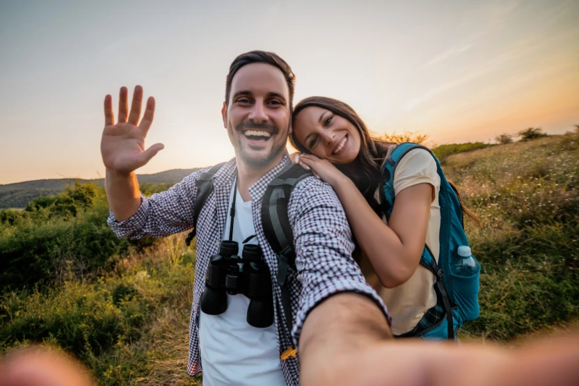 A couple taking a selfie while hiking