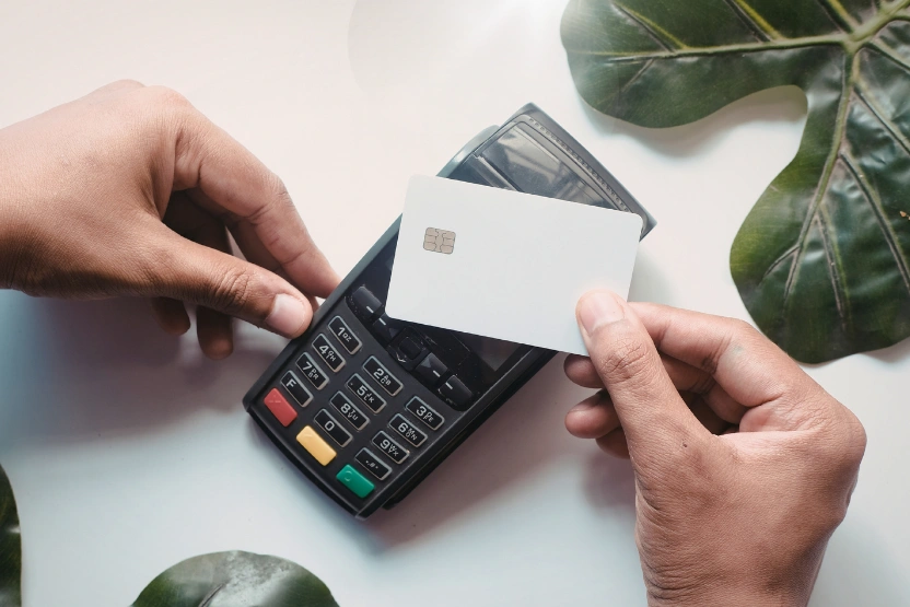 Someone paying with a debit card via contactless method