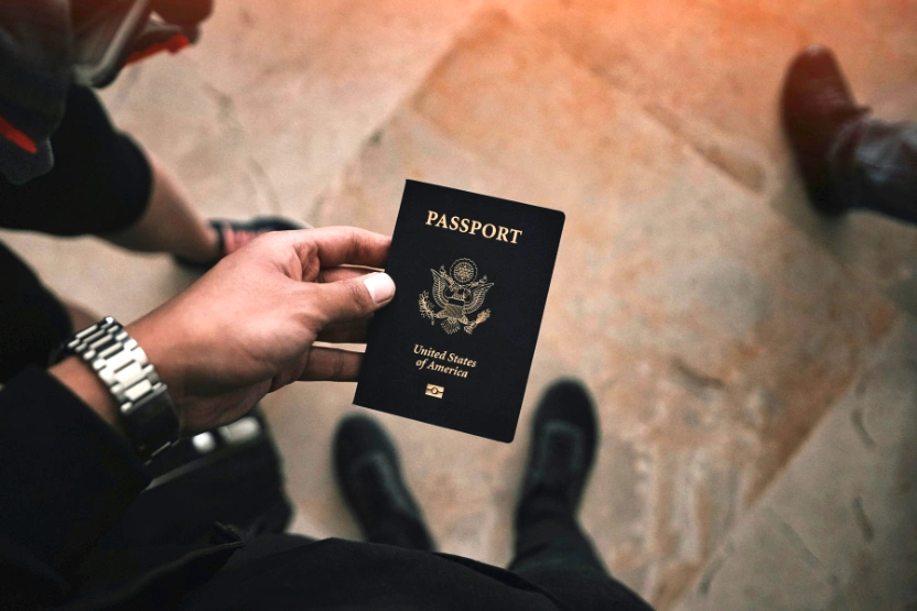 Man holding a US biometric passport in his hand