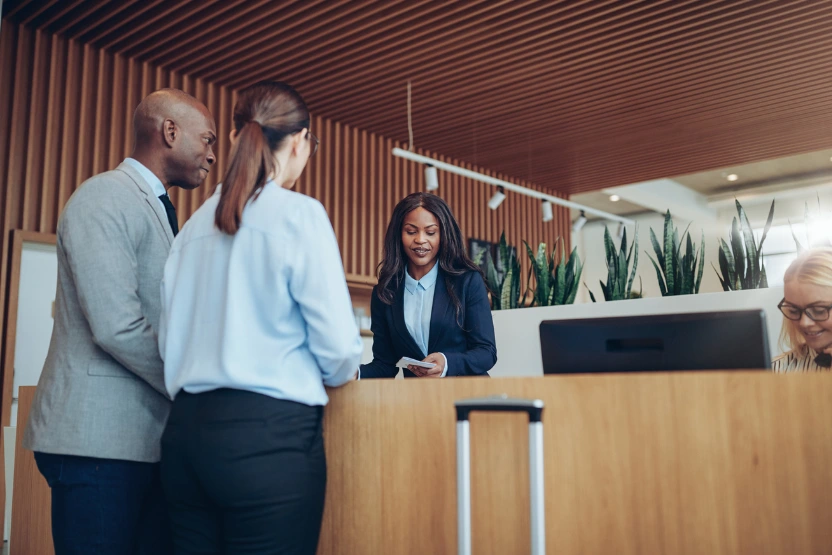 Couple checking into a hotel at the front desk