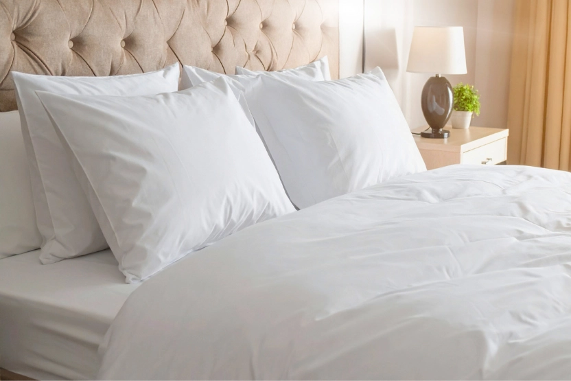 White hotel bed in a warm and cozy room